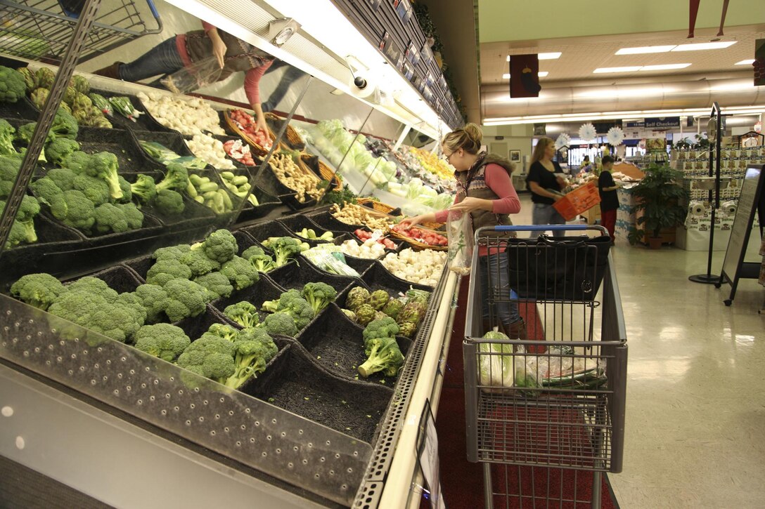 Amber Korpalski selects vegetables from the produce section in the Camp Foster commissary Jan. 8. “The commissary stocks products from the U.S. not available in off base stores. The convenience and familiarity of these products from home can be a great comfort to a family living overseas,” according to John Zaher, the store director of the Camp Foster commissary. Korpalski is a military family member.