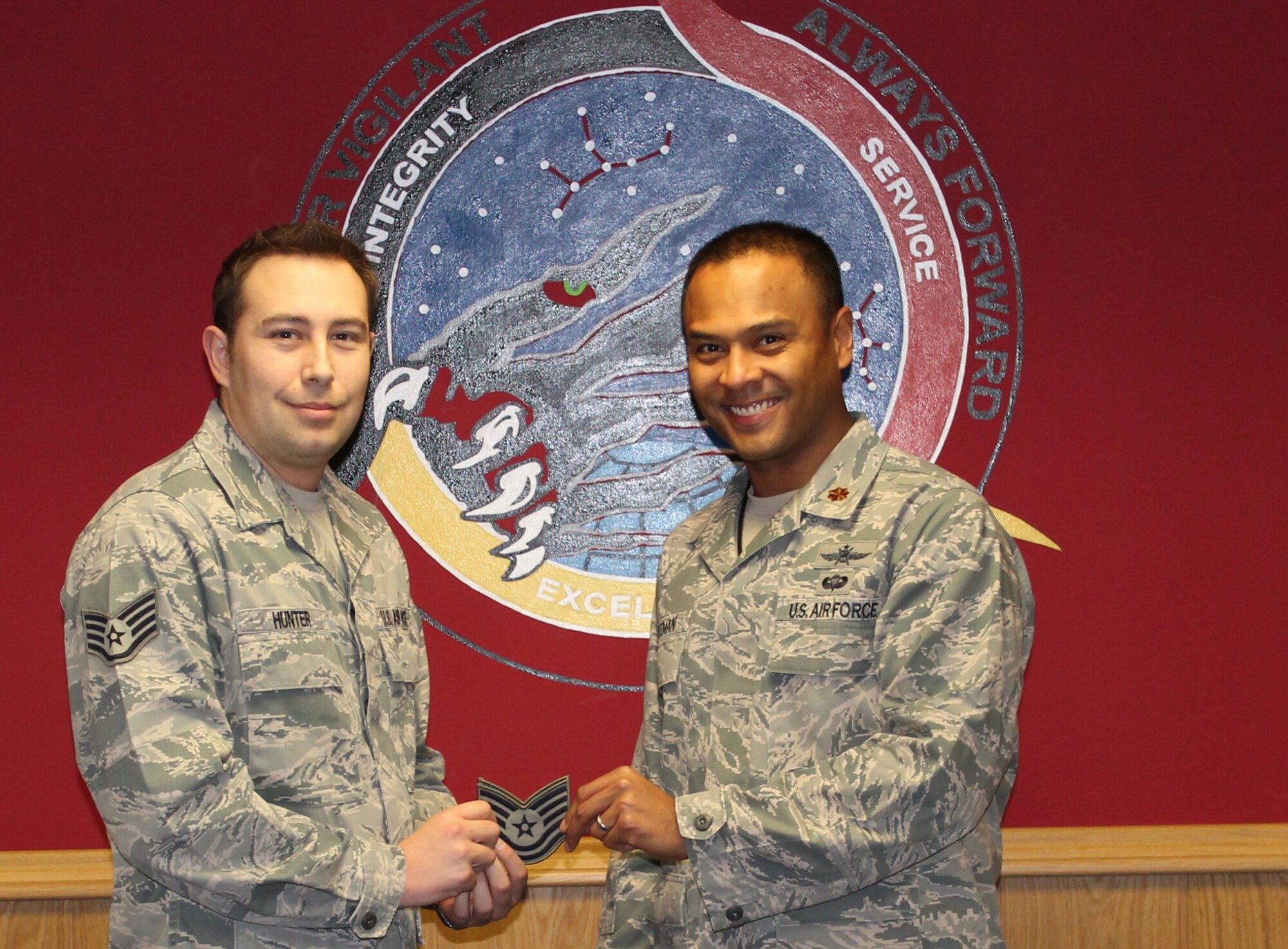 Maj. Douglas Freeman, 460th Space Communications Squadron, Det. 1 commander, informs then Staff Sgt. Benjamin Hunter, 460th SCS, Det. 1 radio frequency transmission technician, of his immediate promotion to technical sergeant Jan. 6, 2013. Hunter was one of two staff sergeants in 14th Air Force selected for a promotion through the Stripes for Exceptional Performers program. (Courtesy photo/Released)