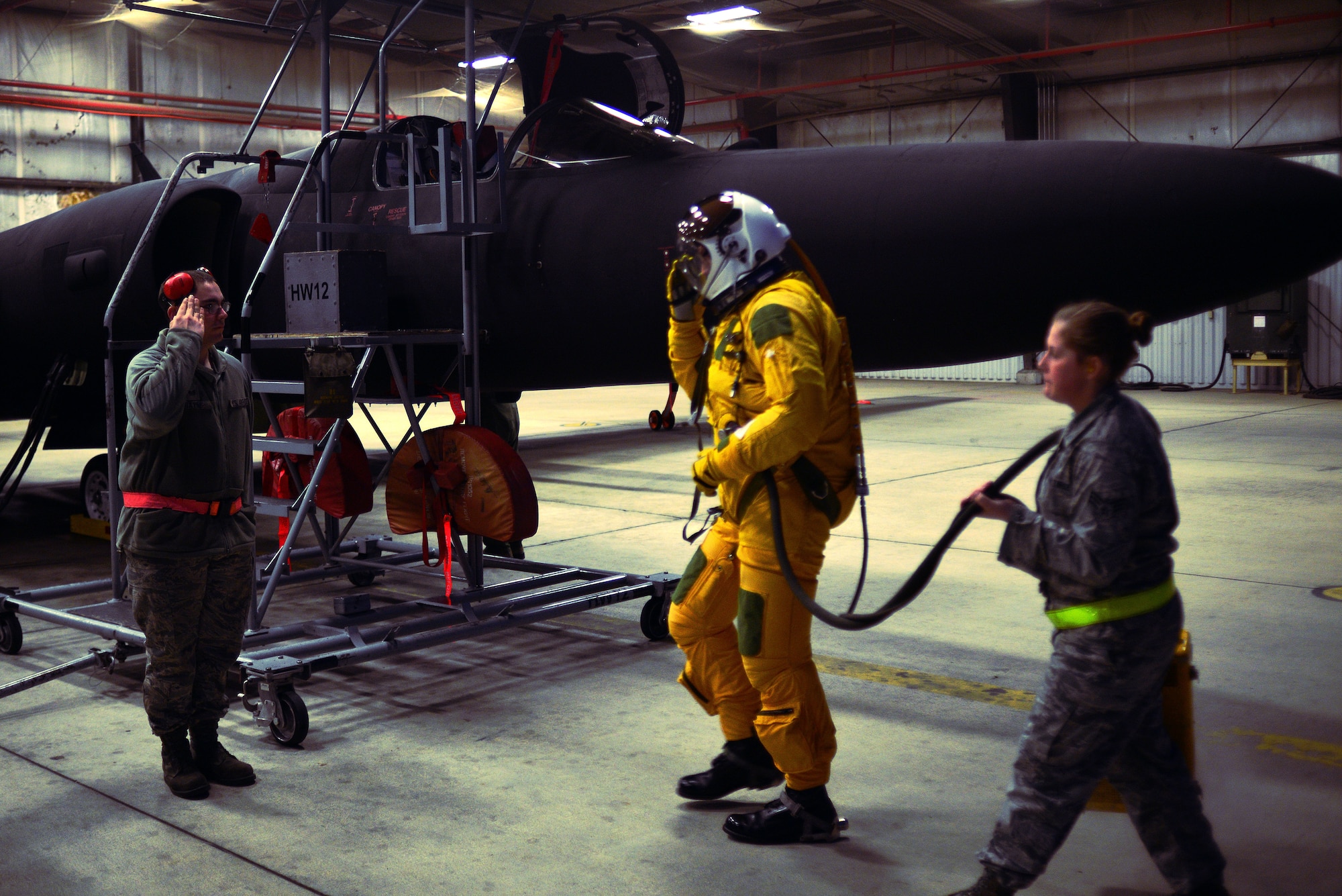 A maintainer from the 9th Aircraft Maintenance Squadron salutes U-2 pilot Capt. Travis as he prepares for a “high flight” in the U-2 Dragon Lady Jan. 8, 2013, at Beale Air Force Base, Calif. (U.S. Air Force photo by Airman 1st Class Drew Buchanan/Released)