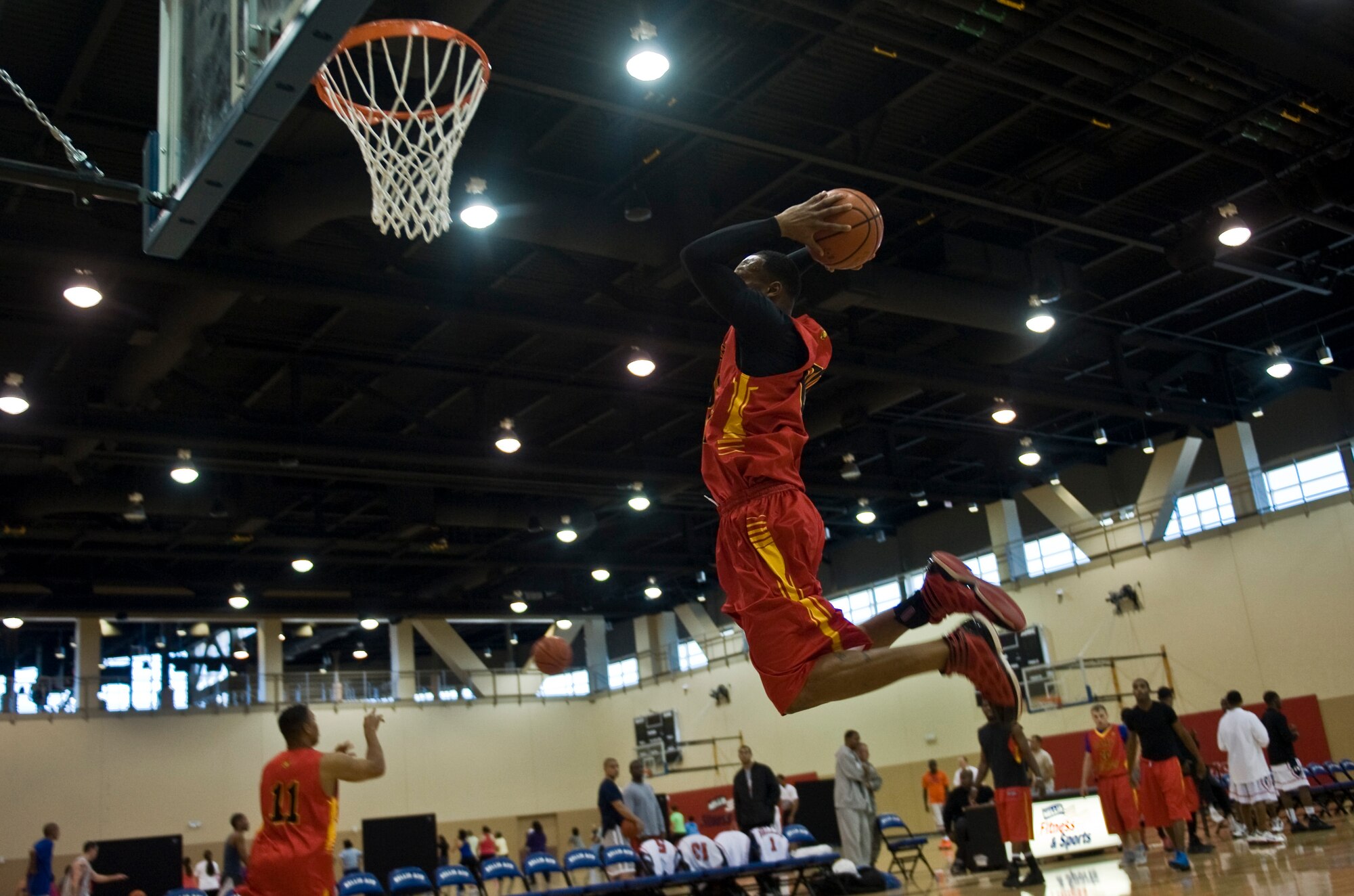 A Marine from Camp Pendleton, Calif. dunks during pregame warm-ups before a Pacific West Military Basketball League Jan. 12, 2013, at Nellis Air Force Base. This is the first time Nellis has hosted the league in the Warrior Fitness Center. (U.S. Air Force photo by Senior Airman Daniel Hughes)
