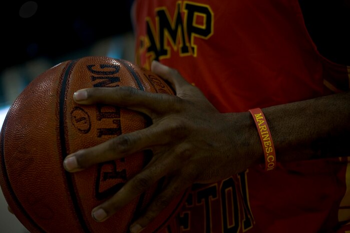 A Marine from Camp Pendleton, Calif. holds a basketball after winning a game against Nellis, Jan. 12, 2013, at Nellis Air Force Base, Nev. Camp Pendleton will be the host of the playoffs, which start at the end of March 2013. (U.S. Air Force photo by Senior Airman Daniel Hughes)