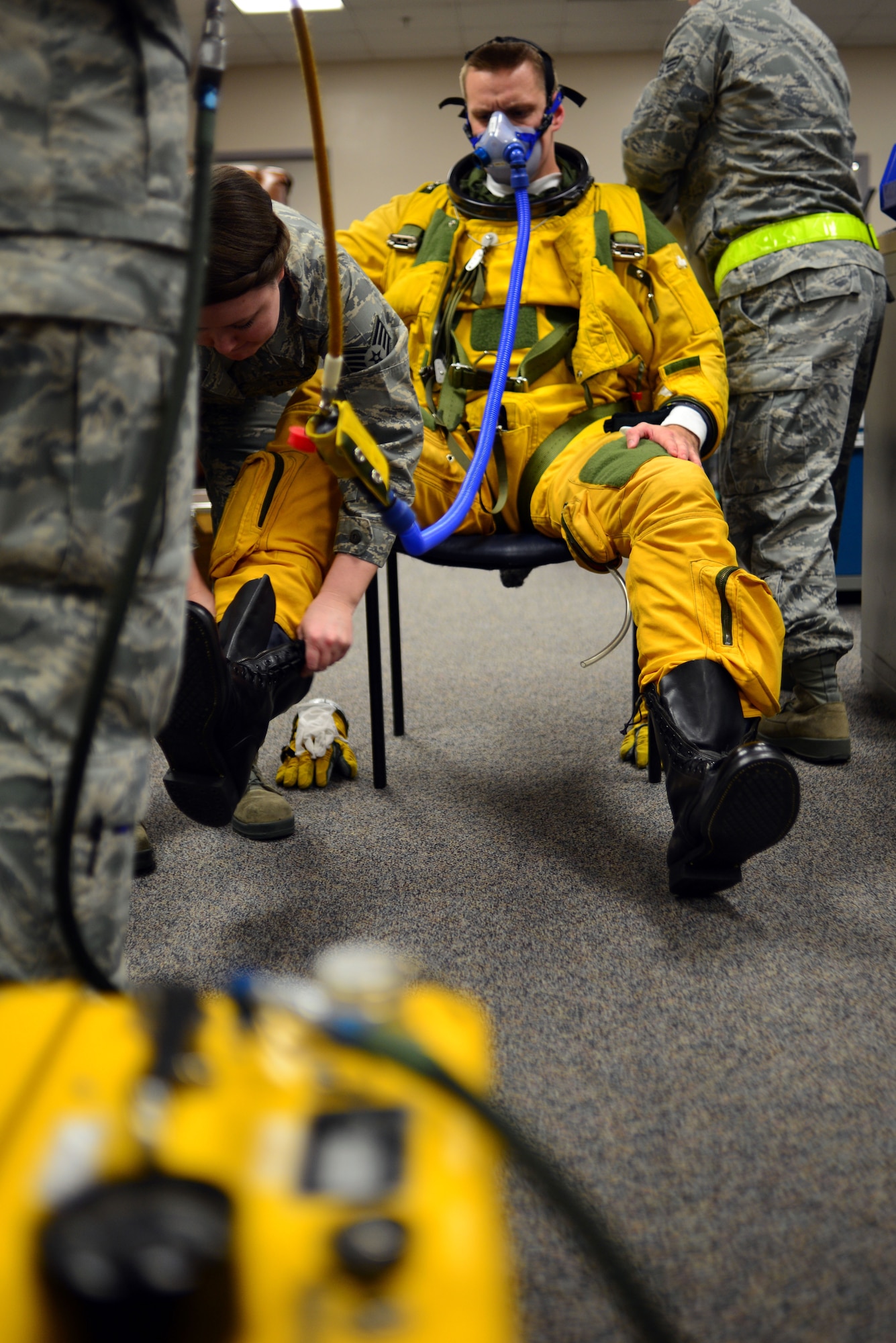 Staff Sgt. Heather Doyle, 9th Physiological Support Squadron launch and recovery technician, fits a specialized boot to U-2 pilot Capt. Travis, in preparation for a "high flight" at Beale Air Force Base, Calif., Jan. 8, 2013. Since its inception in 1955, the U-2 has required the use of a pressure suit to regulate the pressure for pilots above 50,000 feet. The U-2 is the only aircraft in the Department of Defense inventory that requires the utilization of a full pressure suit. (U.S. Air Force photo by Airman 1st Class Drew Buchanan/Released)
