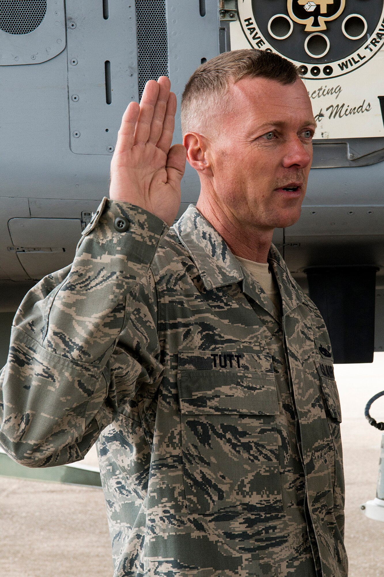 U.S. Air Force Tech. Sgt. Shannon Tutt repeats the Oath of Enlistment, Jan. 14, 2013, Barksdale Air Force Base, La. Tutt is a crew chief assigned to the 917th Aircraft Maintenance Squadron and asked to be reenlisted next to his aircraft, which was crew chiefed by his dad, Tech. Sgt. Jimmy Tutt, for 22 years. (U.S. Air Force photo by Master Sgt. Greg Steele/Released)