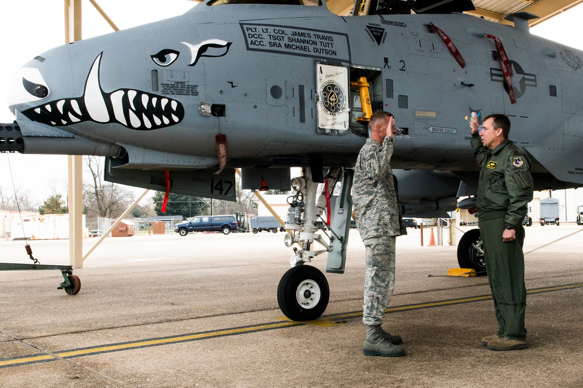 U.S. Air Force Col. John Breazeale, 917th Fighter Group commander, recites the Oath of Enlistment to Tech. Sgt. Shannon Tutt beside an A-10 Thunderbolt II, Jan. 14, 2013, Barksdale Air Force Base, La. Tutt is the Dedicated Crew Chief of the aircraft, tail number 79-0147, which is the same aircraft his dad, Tech. Sgt. Jimmy Tutt, accepted straight from the factory and spent 22 years as its crew chief before retiring from the Air Force Reserve. (U.S. Air Force photo by Master Sgt. Greg Steele/Released)