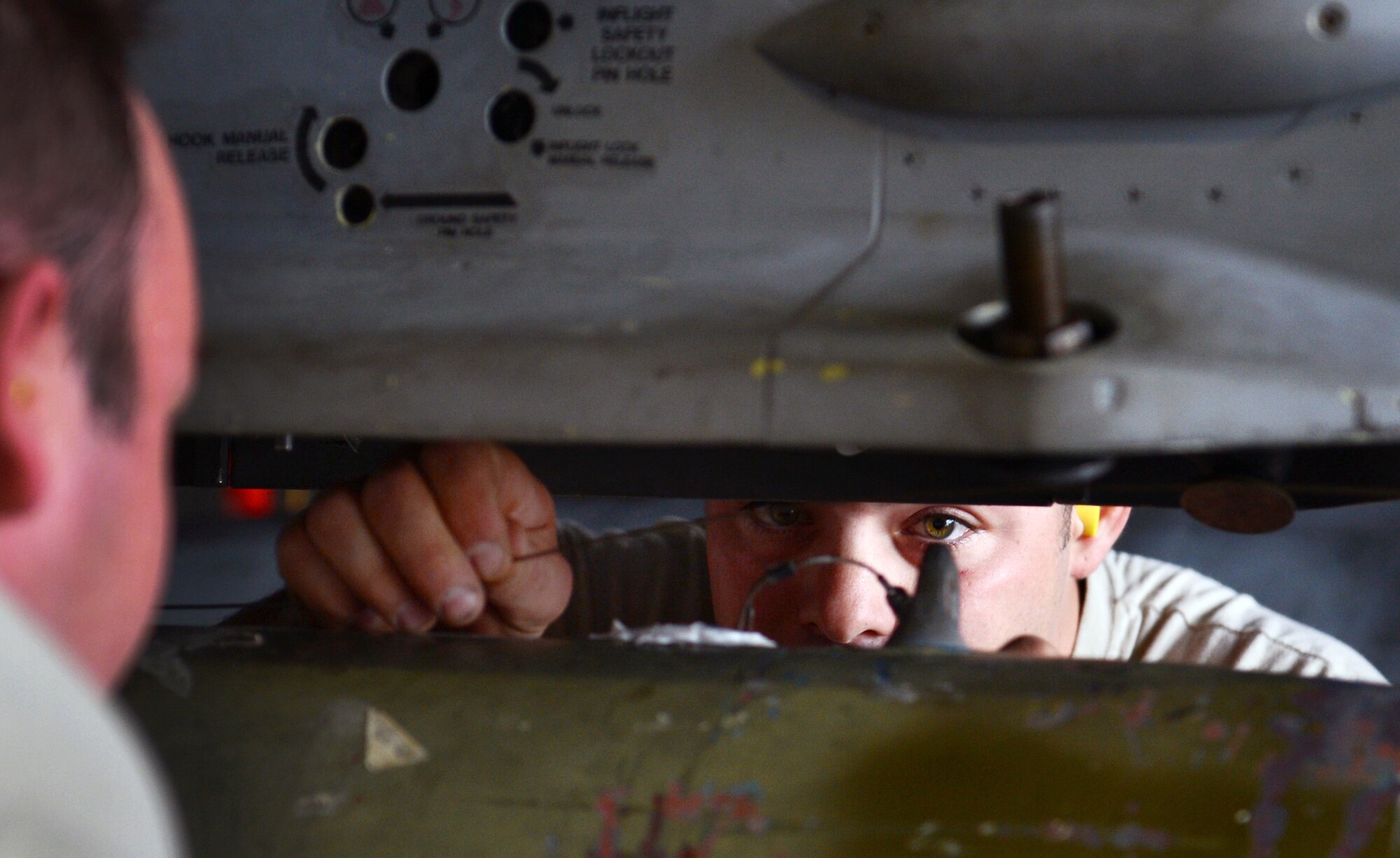 U.S. Air Force Staff Sgt. Joshua Brogden, 20th Aircraft Maintenance Squadron weapons load crew member, secures the arming lanyard onto the F-16 Fighting Falcon at Shaw Air Force Base, S.C., Jan. 11, 2013. During the fourth Weapons Load Crew of the Quarter competition, two crews competed to become eligible for the Load Crew of the Year. The winners were the 79th "Tigers."  (U.S. Air Force photo by Senior Airman Tabatha Zarrella/Released)
