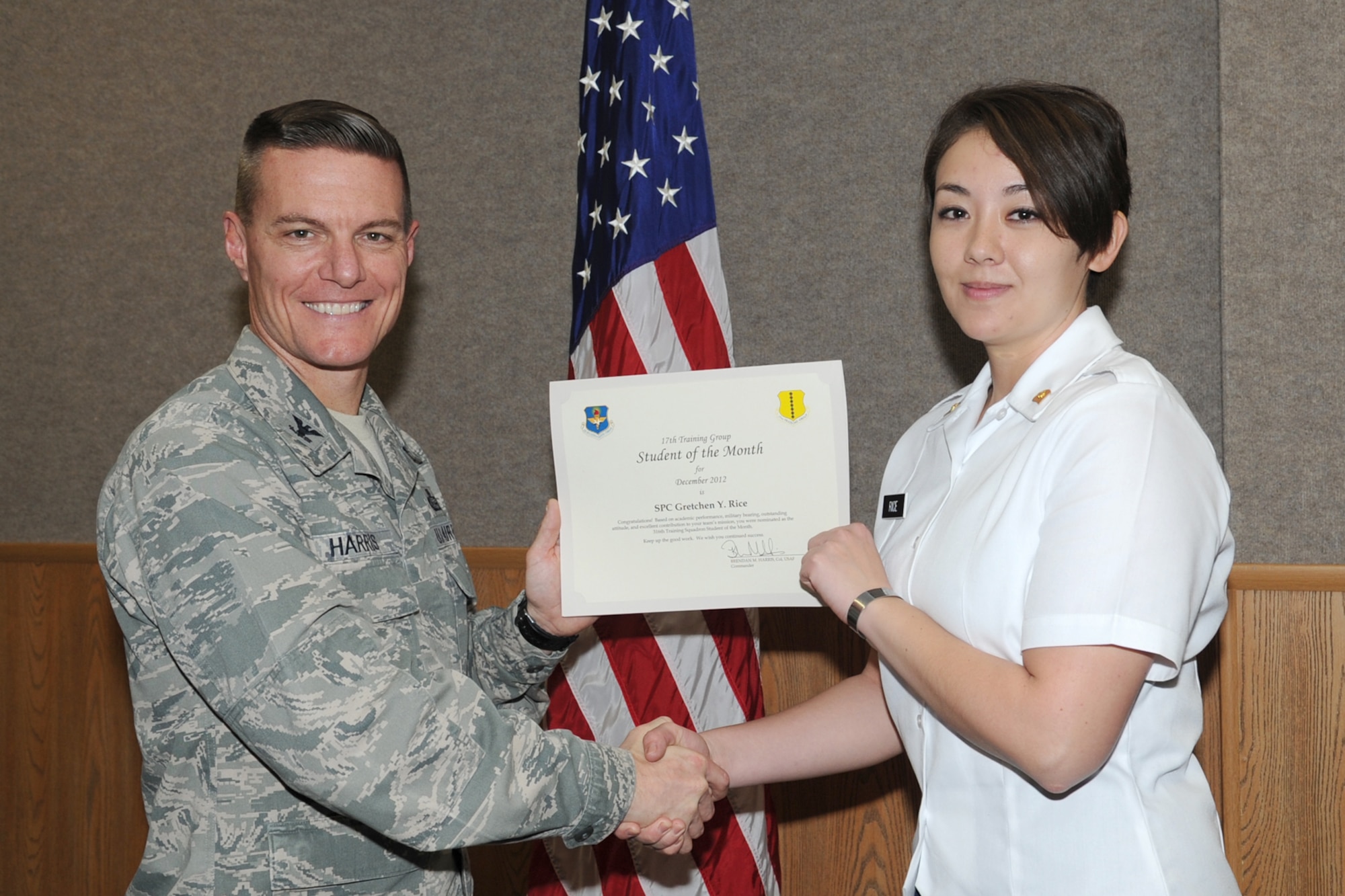 GOODFELLOW AIR FORCE BASE, Texas-- Col. Brendan Harris, 17th Training Group Commander, presents Army Spc. Gretchen Rice with the 316th Training Squadron Student of the Month award for December, Jan. 11. (U.S. Air Force photo/Staff Sgt. Laura R. McFarlane)