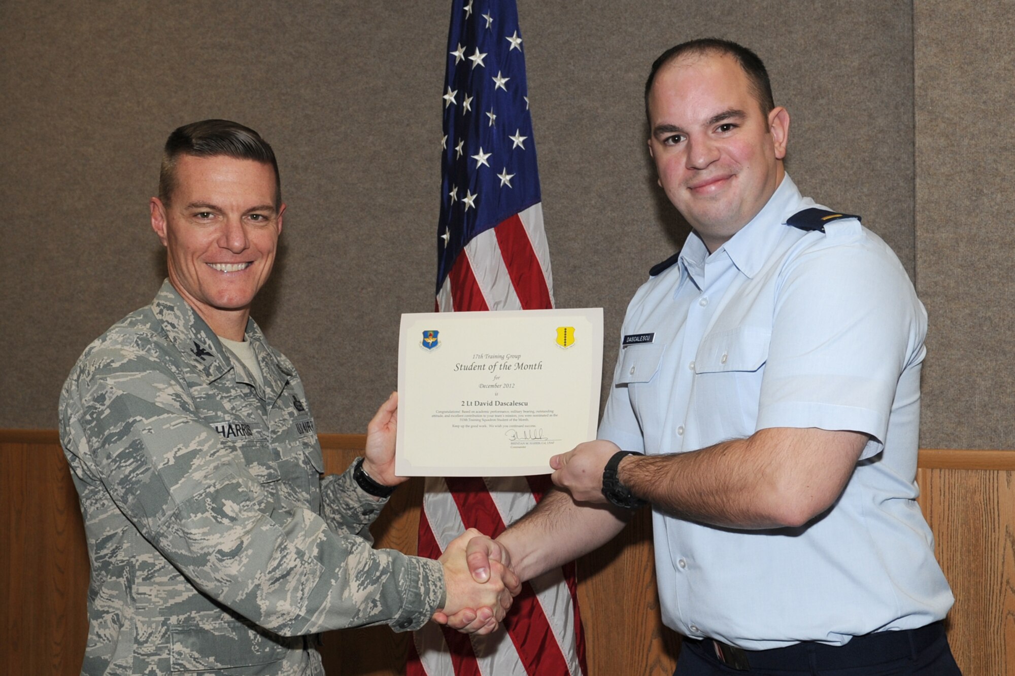 GOODFELLOW AIR FORCE BASE, Texas-- Col. Brendan Harris, 17th Training Group Commander, presents 2nd Lt. David Dascalescu with the 315th Training Squadron Officer Student of the Month award for December, Jan. 11. (U.S. Air Force photo/Staff Sgt. Laura R. McFarlane)