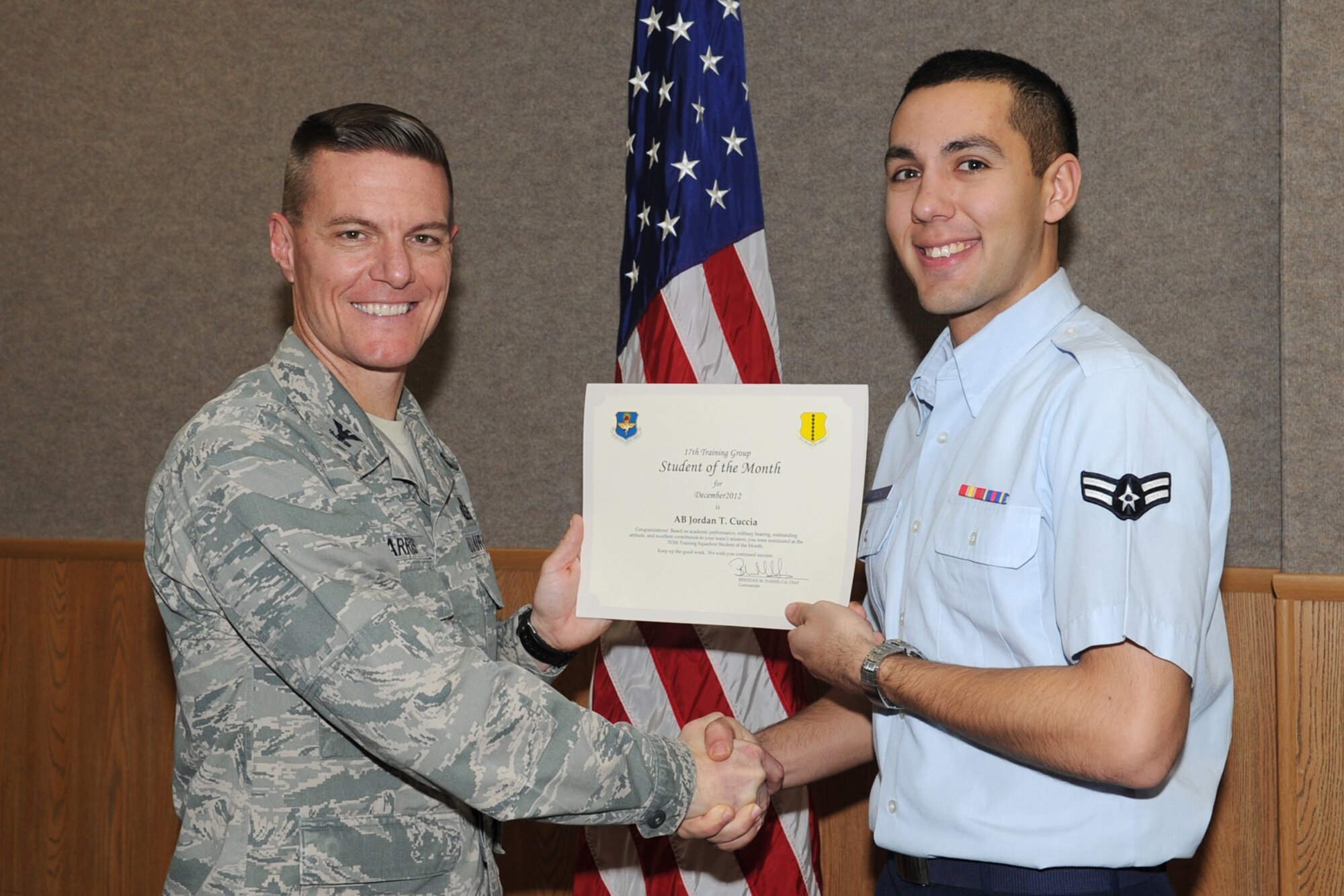 GOODFELLOW AIR FORCE BASE, Texas-- Col. Brendan Harris, 17th Training Group Commander, presents Airman 1st Class Jordan Cuccia with the 315th Training Squadron Enlisted Student of the Month award for December, Jan. 11. (U.S. Air Force photo/Staff Sgt. Laura R. McFarlane)
