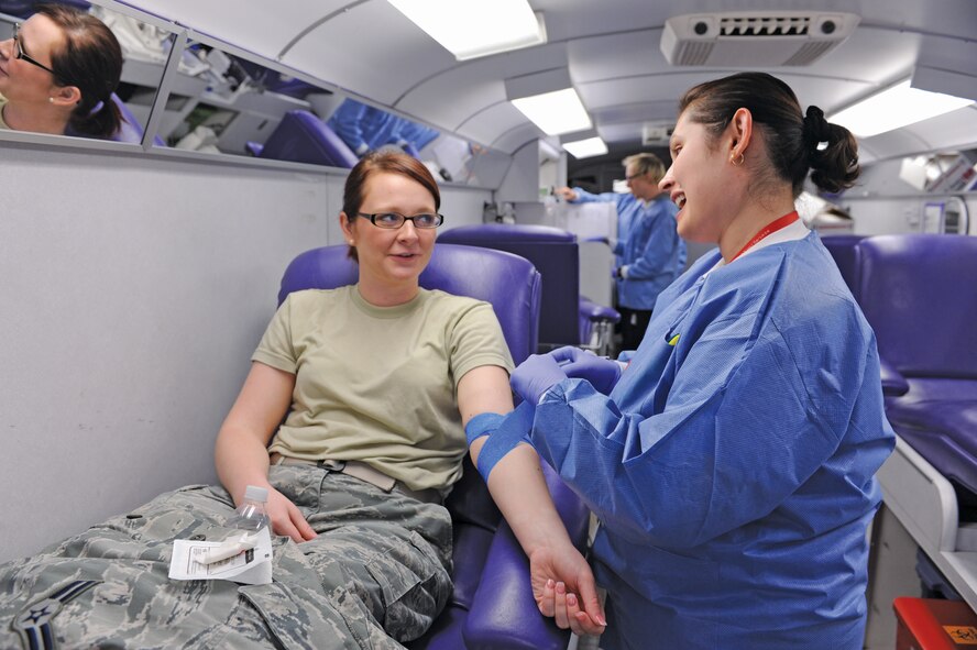 Airman 1st Class Brittany Thompson, 56th Communications Squadron, gets taped up by a Red Cross volunteer Jan. 10 during a blood drive at Club Five Six. There were 90 successful donations from Luke Air Force Base members that had the potential of affecting approximately 270 lives at hospitals in the Phoenix area. (U.S. Air Force photo/Airman 1st Class Devante Williams)