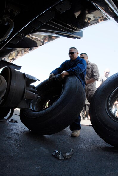 Staff Sgt. Michael Aragon, 56th Logistics Readiness Squadron fuels specialist, prepares to remount a tire onto a vehicle during the tire change event of the Petroleum, Oil and Lubricants rodeo April 28 at the POL compound. During the tire changing event each team had to take two tires off a vehicle, push one around a track and put the tires back on. (U.S. Air Force photo/Airman 1st Class David Owsianka)