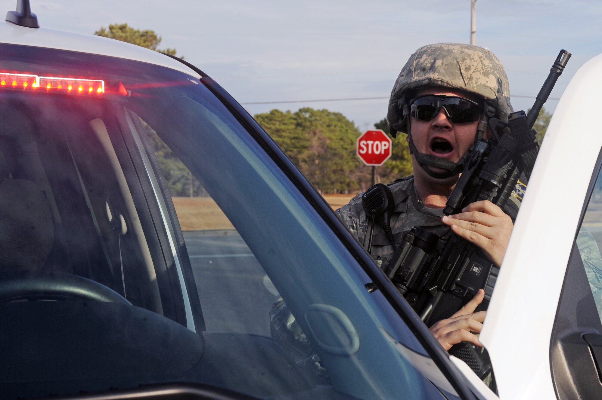 U.S. Air Force Tech. Sgt. Gerald Davis, 4th Security Forces Squadron security controller, shouts commands to a simulated gate runner during Phase I of Operational Readiness Exercise Coronet Warrior 13-01 on Seymour Johnson Air Force Base, N.C., Jan. 14, 2013. The 4th Fighter Wing is conducting numerous OREs in preparation for an upcoming operational readiness inspection. (U.S. Air Force photo/Airman 1st Class John Nieves Camacho/Released)