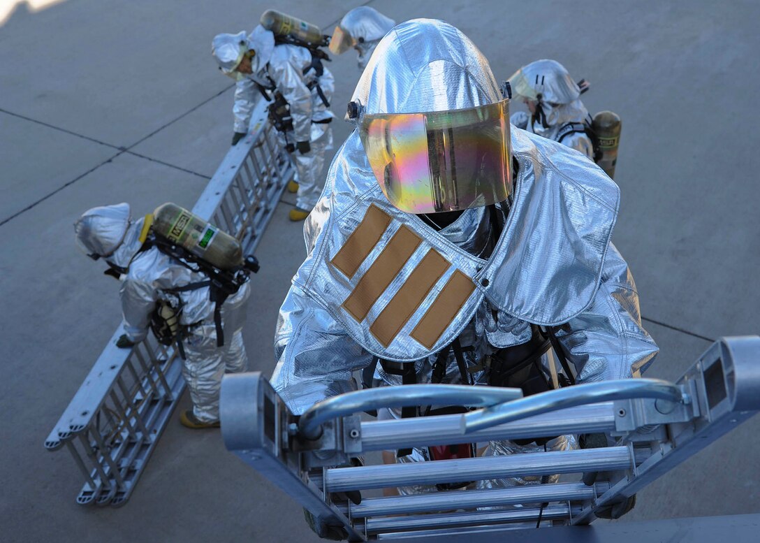 Fire Capt. Paul Haidinger, 56th Civil Engineer Squadron Fire Emergency Services, descends a ladder after a training exercise on a transient KC-135 Stratotanker Feb. 15.(U.S. Air Force photo/Staff Sgt. Darlene Seltmann)