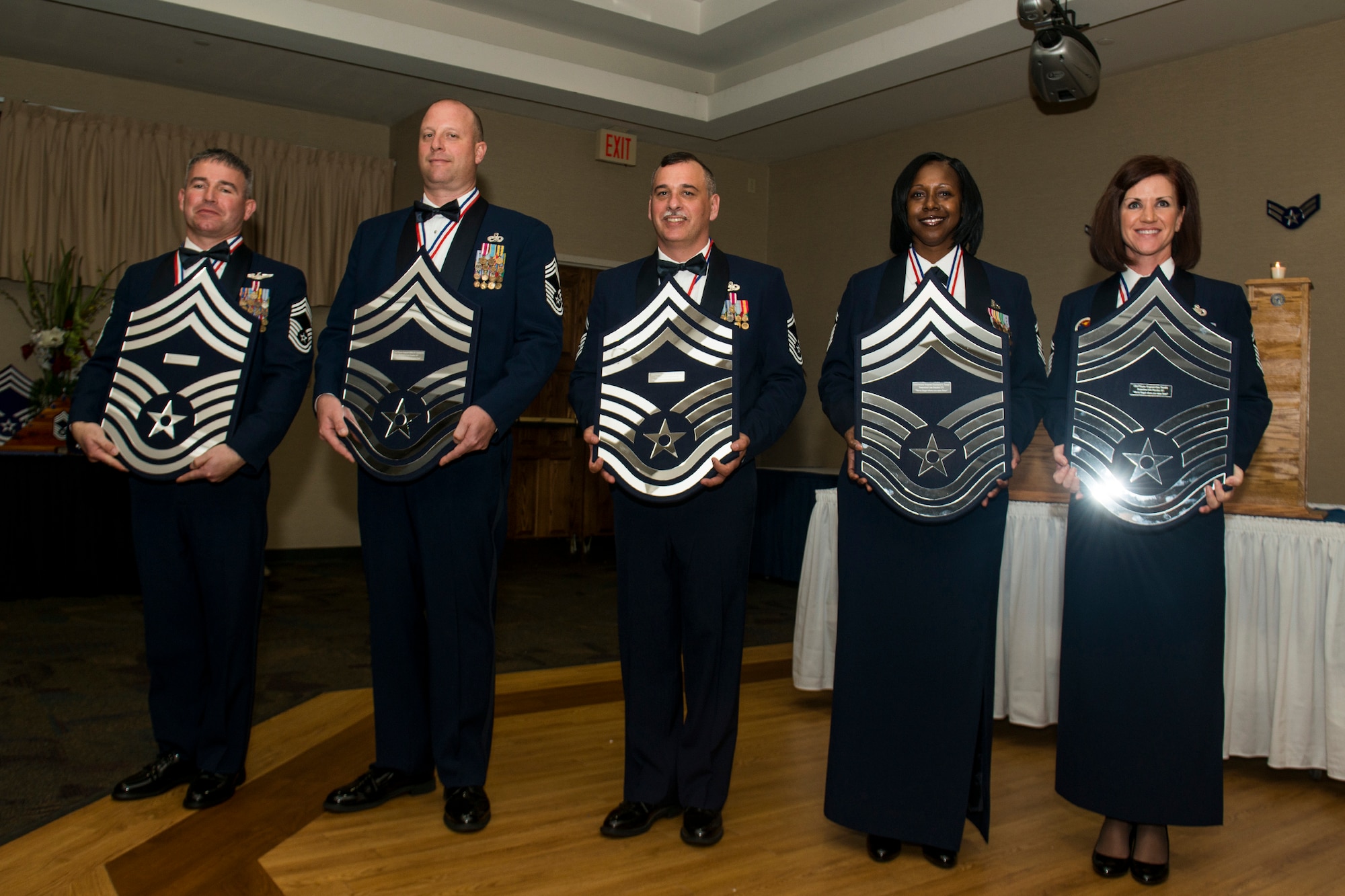 U.S. Air Force Chief Master Sgts. Maxie Gainey and Jeffery Leemon Sr. and Senior Master Sgts. Roy Clayton, Kimberly Turner and Gina Thursby, hold mementos at the conclusion of a chief recognition ceremony Jan. 12, 2013, at Moody Air Force Base, Ga. The event was filled with a night of celebration as Team Moody and guests recognized the Airmen for their dedication to their careers and the Air Force. (U.S. Air Force photo by Staff Sgt. Jamal D. Sutter/Released) 
