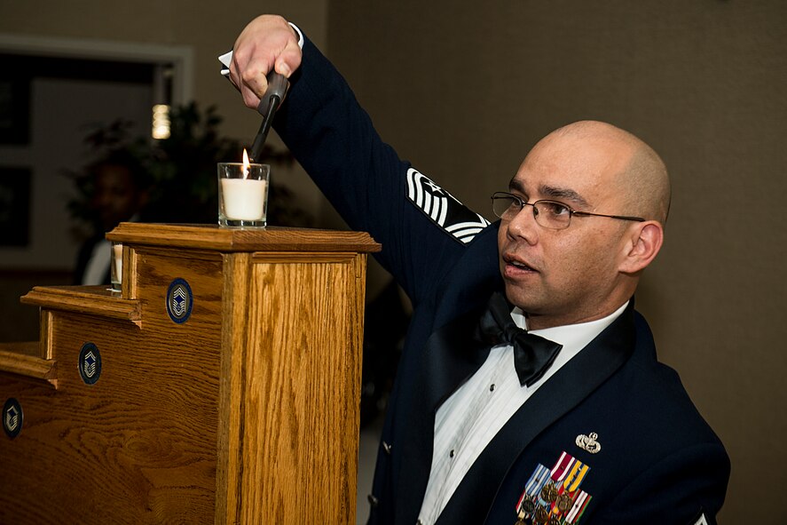 U.S. Air Force Chief Master Sgt. Richard Stiles, 23d Force Support Squadron, lights a candle during a chief recognition ceremony Jan. 12, 2013, at Moody Air Force Base, Ga. Moody Airmen lit nine candles to represent the enlisted ranks of the Air Force and the progression through each rank. (U.S. Air Force photo by Staff Sgt. Jamal D. Sutter/Released)