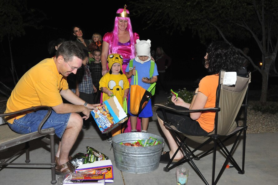 Brig. Gen. Mike Rothstein, 56th Fighter Wing commander, and his wife, Jennifer, hand out candy to trick or treaters Oct. 31 in base housing. (U.S. Air Force photo/Staff Sgt. Jason Colbert)
