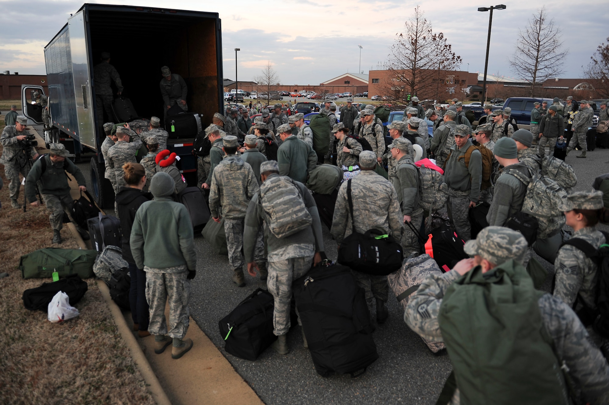 Airmen wait to load luggage into a truck prior to departure for a deployment at Langley Air Force Base, Va., Jan. 8, 2013. The Airmen are assigned to the 192nd Fighter Wing. (U.S. Air Force photo by Staff Sgt. Ciara Wymbs/Released)