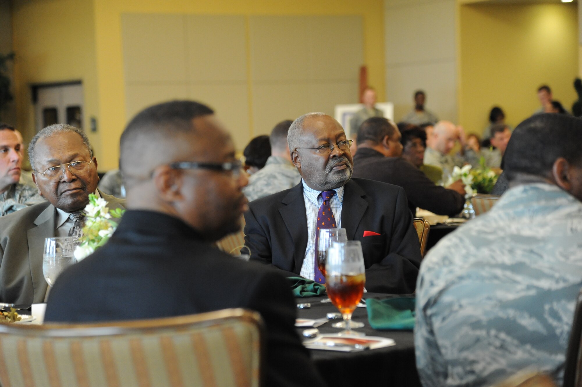 Kurt Higgins, 81st Training Group and African American Heritage Committee president, foreground, listens to the speaker with retired Chief Master Sgt. Charles Bowers, during the annual Dr. Martin Luther King Jr. Memorial Luncheon Jan. 10, 2013, at the Bay Breeze Event Center, Keesler Air Force Base, Miss.  The guest speaker for the event was Lt. Gen. Darren McDew, 18th Air Force commander, Scott Air Force Base, Ill.  (U.S. Air Force photo by Kemberly Groue)