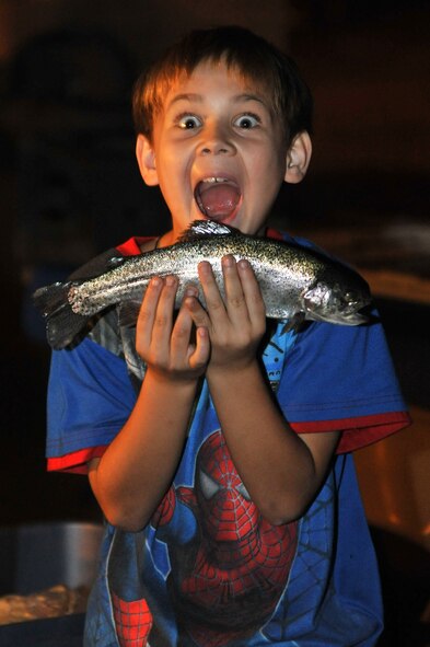 Dylan Phillip, 9, son of Tech. Sgt. Jason Phillip, 56th Equipment Maintenance Squadron Combat Armament support team chief, poses with a fish he caught Nov. 2 during the family campout and fishing derby held at Silver Wings Park. The pool was stocked with trout with an unlimited catch. (U.S. Air Force photo/Senior Airman Sandra Welch)