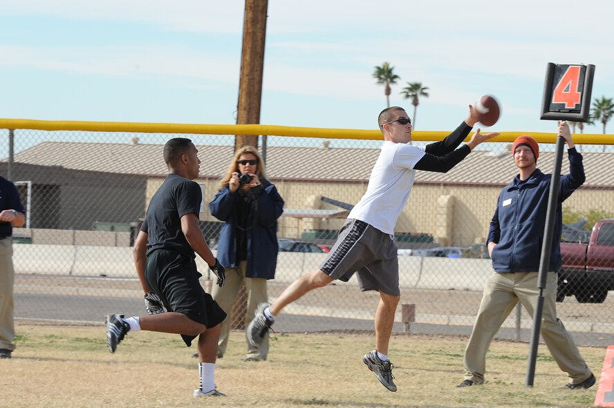 Travis Gonzalez, 756th Aircraft Maintenance Squadron resource advisor, catches a pass to win the 3-on-3 flag football game during the winter games Dec. 12 at Luke Air Force Base’s Bryant Fitness Center softball field. AMXS placed third in the tournament. (U.S. Air Force photo/Airman 1st Class James Hensley)
