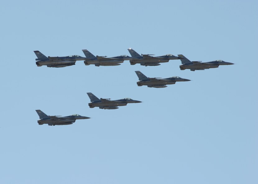 A formation of seven F-16 Fighting Falcons performs a flyover April 30 at Luke Air Force Base. These aircraft represent Luke’s six fighter squadrons and are flying with the 56th Fighter Wing’s flagship aircraft. Luke’s mission is to train the world’s greatest F-16 fighter pilots and maintainers, while deploying mission-ready warfighters. (U.S. Air Force photo/Senior Master Sgt. Rich Puckett)