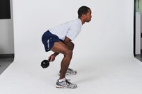 Kettlebell swing
Grab a kettlebell with an overhand grip and hold it at arm?s length. Bend hips and knees, then lower torso until it forms a 45-degree angle to the floor. Swing the kettlebell between legs, keeping arms straight, while thrusting hips forward. Straighten knees and swing the kettlebell up to chest level while rising to standing position. Repeat pattern for all reps.  ( U.S. Air Force photo by Don Lindsey)
