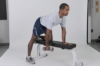 Dumbbell single-arm row
Grab a dumbbell with left hand and place right hand and right knee on a flat bench. Lower back should be naturally arched and torso roughly parallel to the floor. Keep upper arm perpendicular to body and row the weight toward side of chest. Pause, then return to starting position. Complete all reps, then switch sides and repeat. ( U. S. Air Force photo by Don Lindsey ) 
