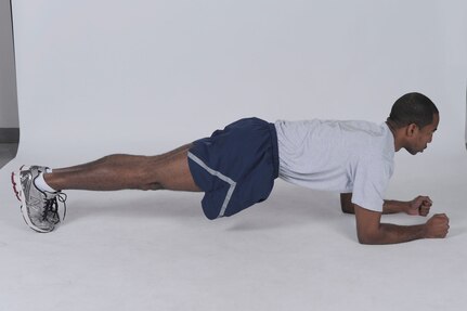 Hover plank
Get into a pushup position, but bend elbows to rest weight on forearms instead of hands. The body should form a straight line from shoulders to ankles. Brace core by contracting abs. Hold position for the desired time. ( U.S. Air Force photo by Don Lindsey
