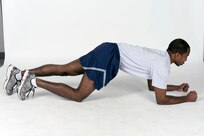 Hover plank
Get into a pushup position, but bend elbows to rest weight on forearms instead of hands. The body should form a straight line from shoulders to ankles. Brace core by contracting abs. Hold position for the desired time. ( U.S. Air Force pho by Don Lindsey)
