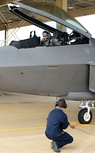U.S. Air Force Staff Sgt. Alvin Salguero, 94th Air Maintenance Unit F-22 crew chief, and Lt. Col. Darren Gray, 192nd Fighter Wing pilot, prepares an F-22 Raptor takeoff at Langley Air Force Base, Va., Jan. 11, 2013.  F-22 Raptors and approximately 300 Airmen from the 1st Fighter Wing and the 192nd Fighter Wing deployed to Kadena Air Base, Japan. (U.S. Air Force photo by Senior Airman Kayla Newman/Released)