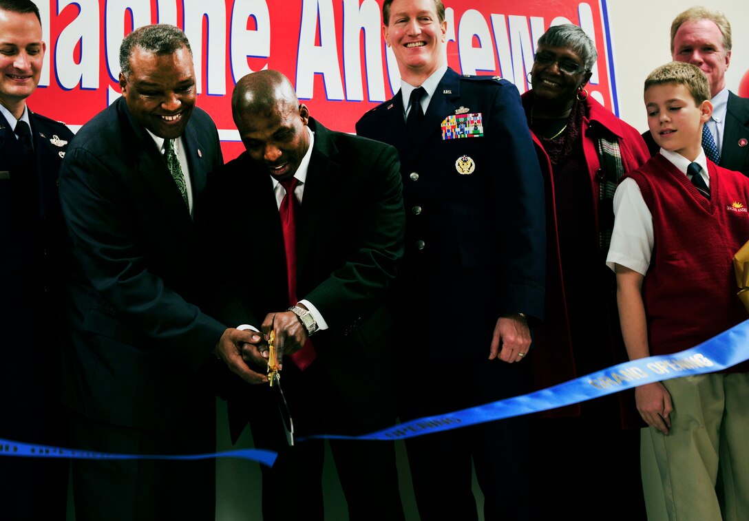 Honorable Rushern Baker (left), Prince George's County Executive, and Dr. Marquis Dwarte, Principal, join hands to perform the ribbon-cutting at the newly opened public charter school, Jan. 14, 2013 on Joint Base Andrews, Md. The new building provides larger classrooms, a multi-purpose room, as well as a media and music room. (U.S. Air Force photo/ Airman 1st Class Erin O’Shea) 