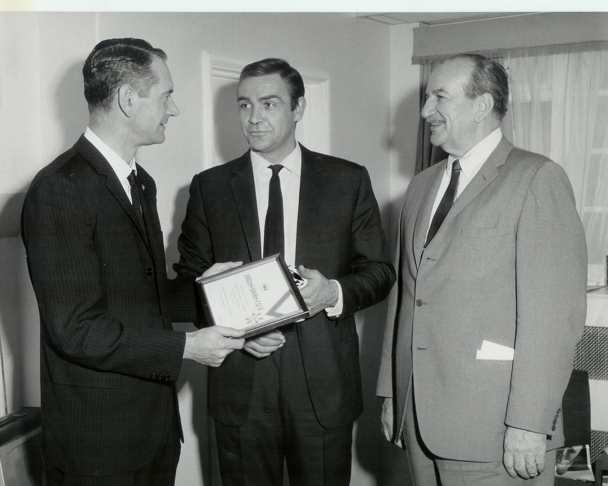 Sean Connery is welcomed to the TWA Ambassadors Club during the production of “Thunderball.” Retired Lieutenant Colonel Charles Russhon, military advisor to the James Bond films in the ‘60s and ‘70s and friend of Sean Connery’s, is to his right. (Photo courtesy of Christian Russhon)