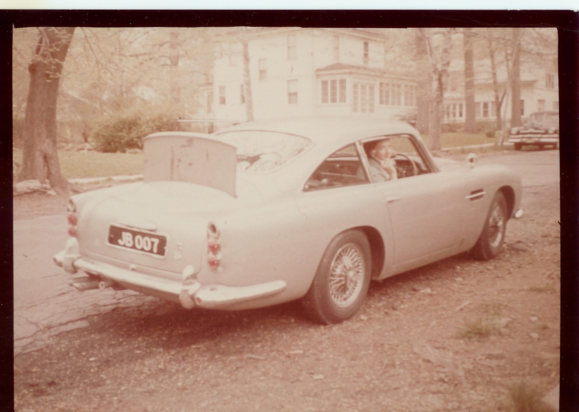 Claire Russhon, wife of Retired Lieutenant Colonel Charles Russhon, military advisor to the James Bond films in the ‘60s and ‘70s, poses in the Aston Martin DB5 made famous in the films. (Photo courtesy of Christian Russhon)