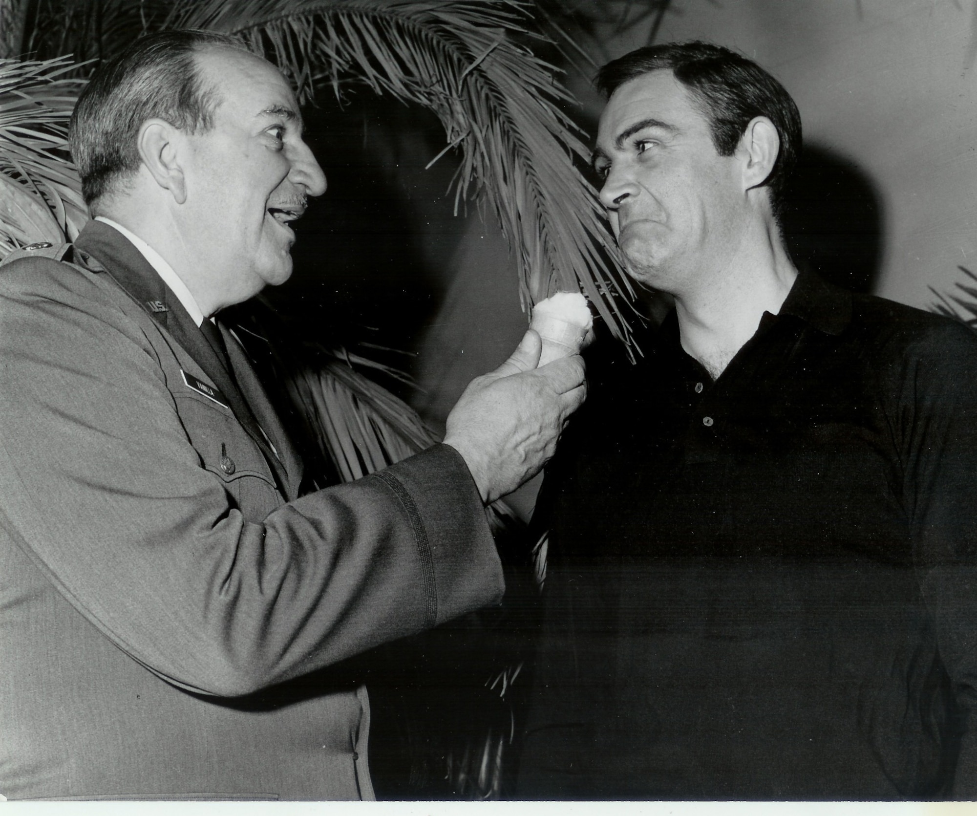 Retired Lieutenant Colonel Charles Russhon, military advisor to the James Bond films in the ‘60s and ‘70s, feigns shoving a vanilla ice cream cone in Sean Connery’s face during the production of “Thunderball.” Russhon and Connery became friends on set. The vanilla ice cream cone had special significance to Russhon, who inspired the “Charlie Vanilla” character, an ice cream loving mister fix-it, in friend and esteemed American cartoonist Milton Caniff’s comic strip “Steve Canyon.” (Photo courtesy of Christian Russhon)