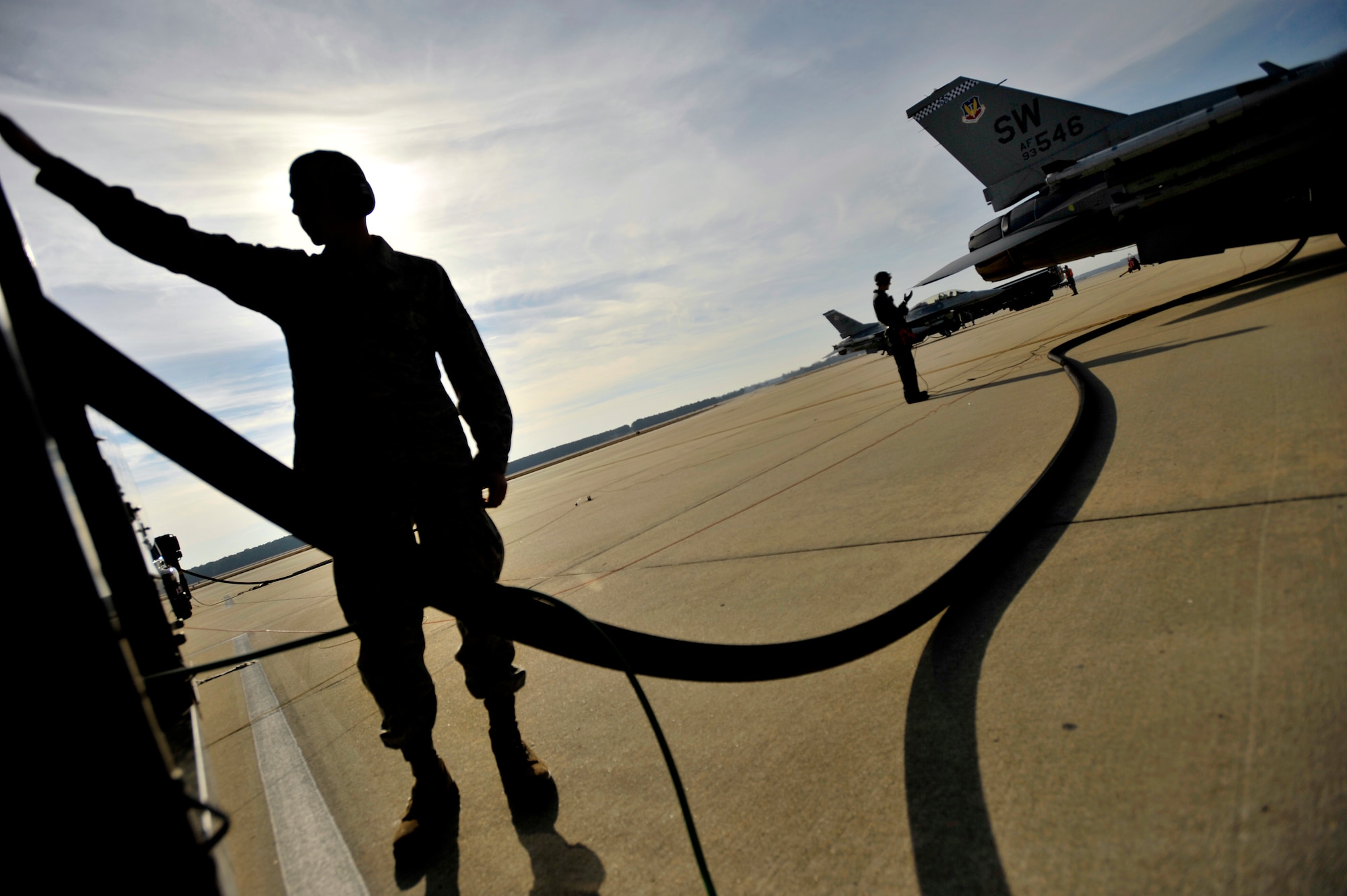 U.S. Air Force Airman 1st Class Jonathan Hinesley, 20th Logistics Readiness Squadron fuels operator, operates the fuel truck controls while refueling F-16 Fighting Falcons, Jan. 10, 2013, Shaw Air Force Base, S.C. Fuels operators and crew chiefs such as Brightwell performed hot pit refueling procedures for both the 55th and 79th Fighter Squadrons. Hot pit refueling is a procedure usually performed in a combat situation to rapidly refuel aircraft while their engines are running resulting in a speedy refuel to thrust pilots back into the fight. (U.S. Air Force photo by Staff Sgt. Kenny Holston)(Released)