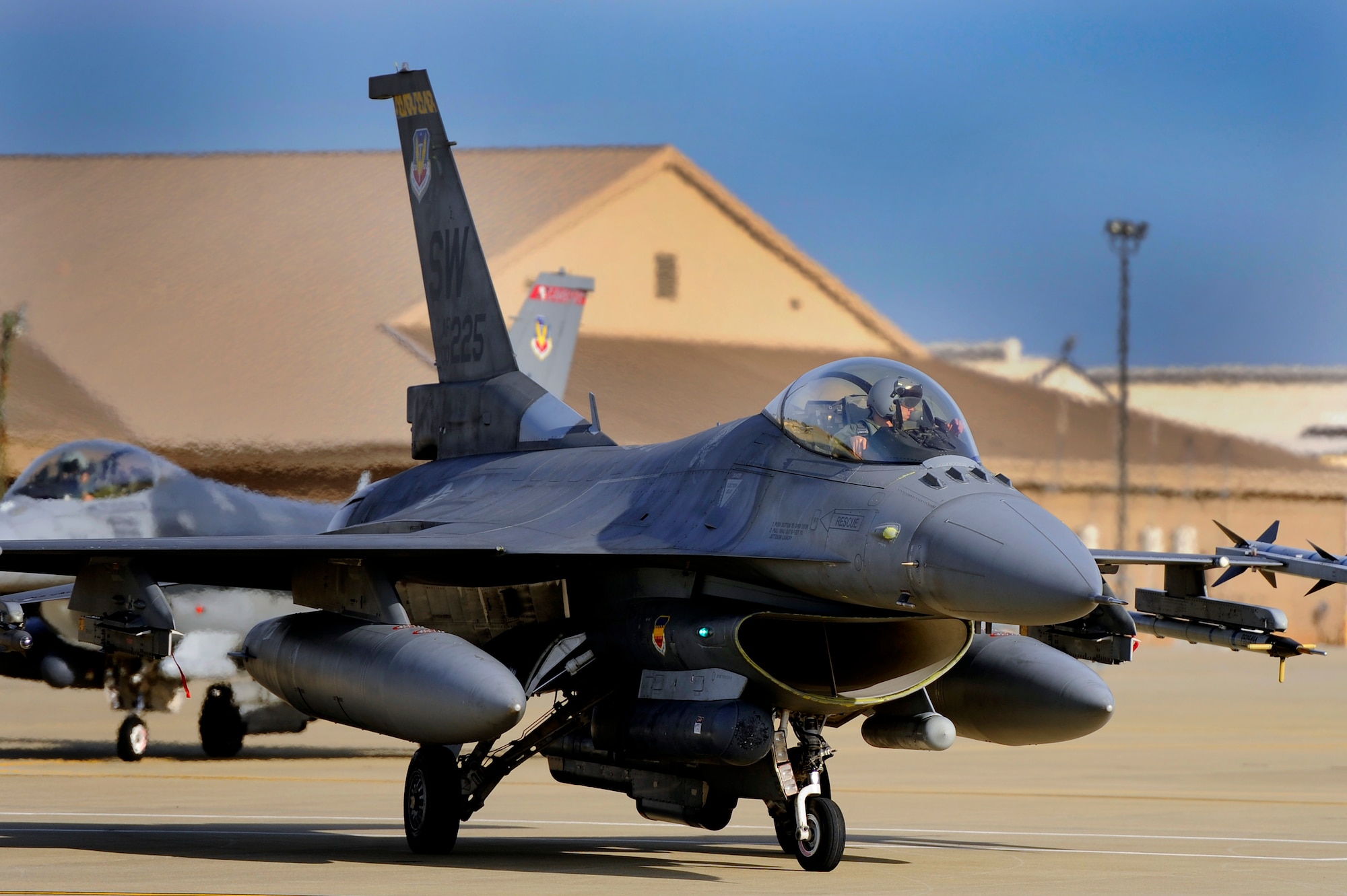 A U.S. Air Force F-16 Fighting Falcon pilot with the 79th Fighter Squadron taxis his aircraft into the “hot pit” to be refueled after performing routine sorties, Jan. 10, 2013, Shaw Air Force Base, S.C. Fuels operators and crew chiefs performed hot pit refueling procedures for both the 55th and 79th Fighter Squadrons. Hot pit refueling is a procedure usually performed in a combat situation to rapidly refuel aircraft while their engines are running resulting in a speedy refuel to thrust pilots back into the fight. (U.S. Air Force photo by Staff Sgt. Kenny Holston)(Released)