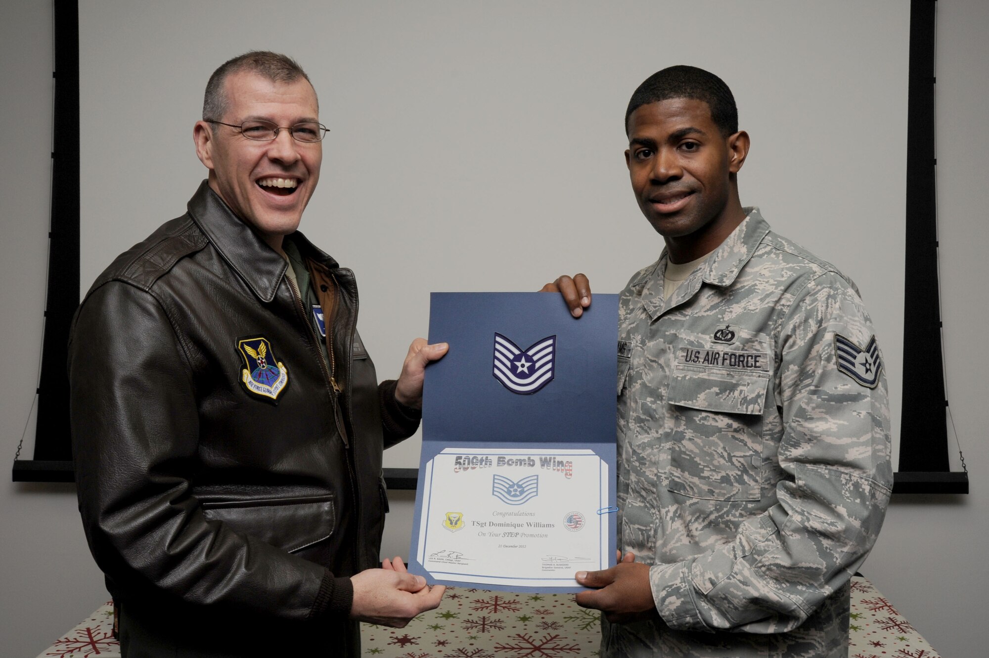 WHITEMAN AIR FORCE BASE, Mo. -- Brig. Gen. Thomas A. Bussiere, 509th Bomb Wing commander, presents Tech. Sgt. Dominique Williams, 509th Operations Support Squadron NCOIC of wing scheduling, with a certificate of recognition for his Stripes for Exceptional Performers promotion to technical sergeant Dec. 20. The STEP program allows Air Force leaders to select Airmen with outstanding potential for promotion to the grades of staff sergeant through master sergeant. (U.S. Air Force photo/Staff Sgt. Nick Wilson)(Released)