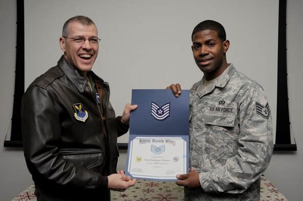 Brig. Gen. Thomas A. Bussiere, 509th Bomb Wing commander, presents Tech. Sgt. Dominique Williams, 509th Operations Support Squadron NCOIC of wing scheduling, with a certificate of recognition for his Stripes for Exceptional Performers promotion to technical sergeant Dec. 20 at Whiteman Air Force Base, Mo. The STEP program allows Air Force leaders to select Airmen with outstanding potential for promotion to the grades of staff sergeant through master sergeant. (U.S. Air Force photo/Staff Sgt. Nick Wilson) (Released)