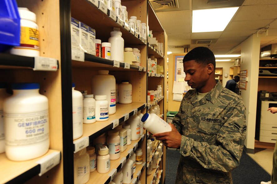 WHITEMAN AIR FORCE BASE, Mo. -- Airman 1st Class Isaiah Hursey, 509th Medical Support Squadron medical logistics customer service technician, removes expired drugs from the shelf in the Pharmacy, Jan. 7. Hursey is making sure drugs are up to date for patient safety. (U.S. Air Force photo/Staff Sgt. Nick Wilson) (Released)