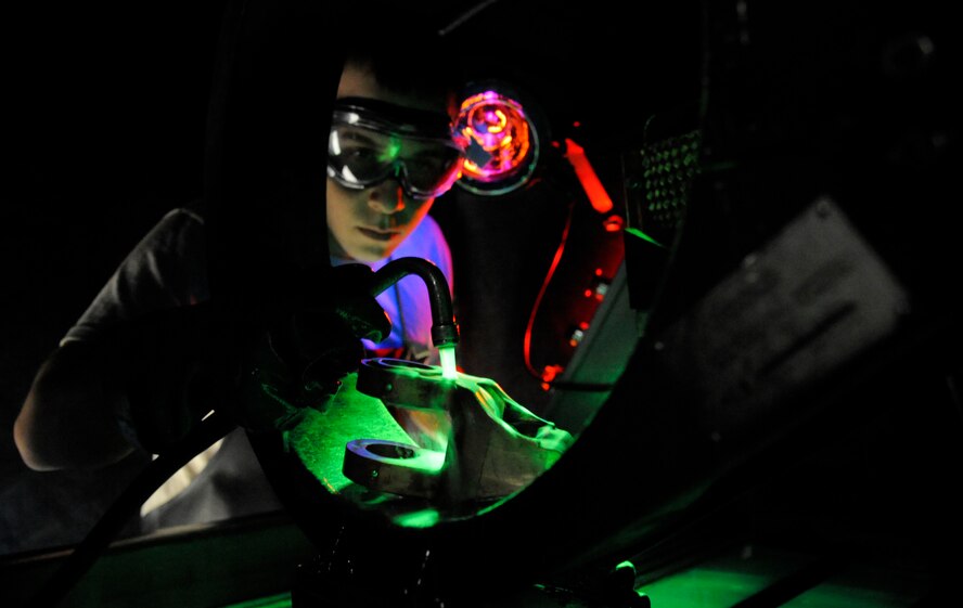 Senior Airman Joshua Martinez, 2nd Maintenance Squadron non-destructive inspection section, sprays a magnetic particle solution onto a B-52H Stratofortress engine mount on Barksdale Air Force Base, La., Jan. 11. The solution helps repair parts by filling in cracks and other damage. (U.S. Air Force photo/Airman 1st Class Andrew Moua)