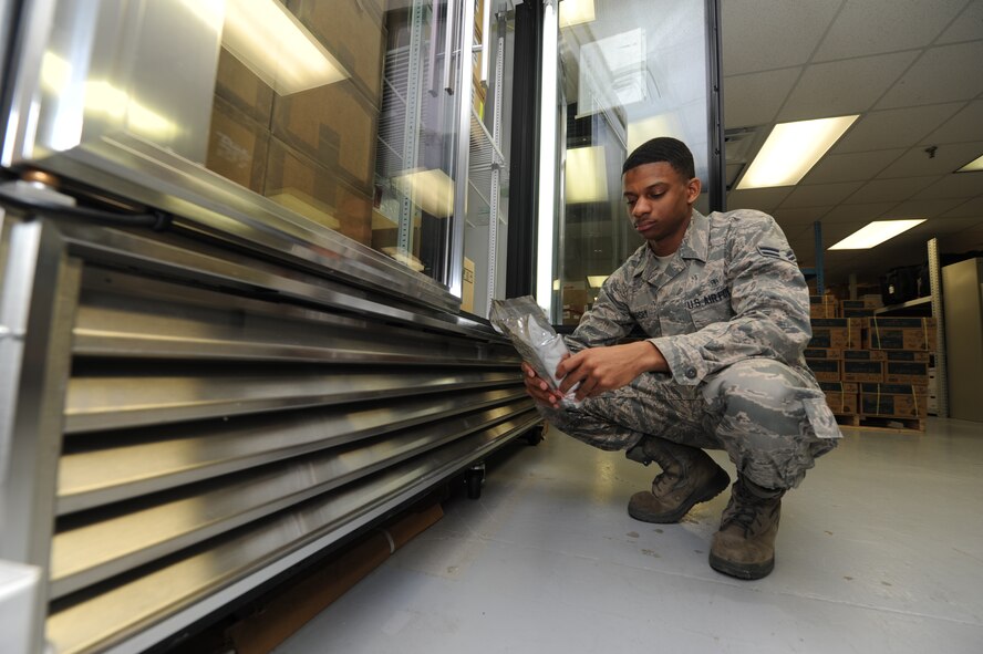 WHITEMAN AIR FORCE BASE, Mo. -- Airman 1st Class Isaiah Hursey, 509th Medical Support Squadron medical logistics customer service technician, ensures quality assurance data is verified on temperature sensitive controlled medication, Jan.7. Hursey ensures data is verified according to name, strength and temperature control. (U.S. Air Force photo/Staff Sgt. Nick Wilson) (Released)