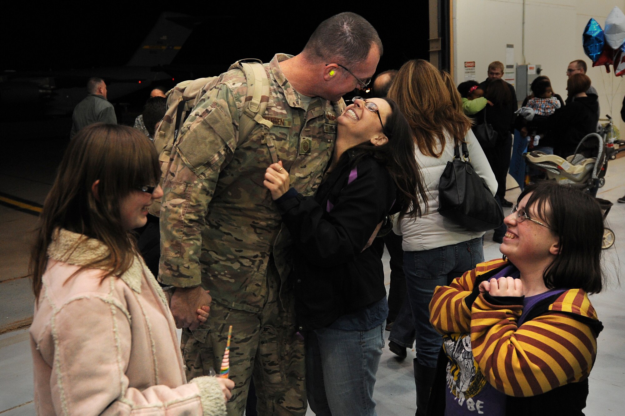 Families come together during Operation Homecoming at Cannon Air Force Base, N.M., Jan. 7, 2013.  Operation Homecoming is a monthly event that reunites Cannon's Air Commandos with their loved ones.  (U.S. Air Force photo/Senior Airman Jette Carr)