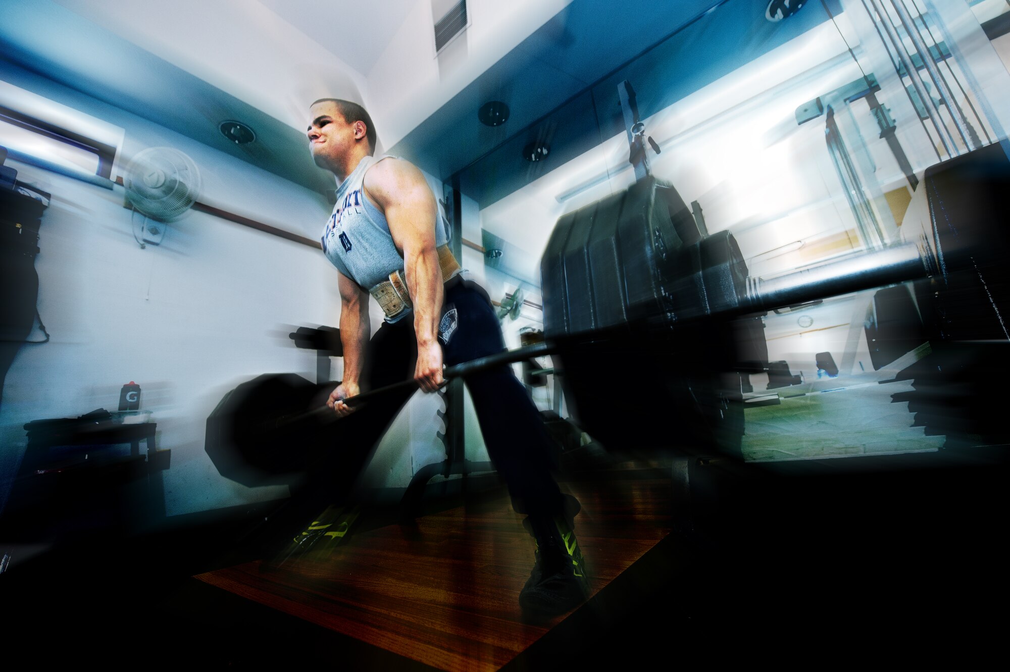 Senior Airman Brandon Stout, 28th Civil Engineer Squadron fire and emergency services driver operator, dead lifts 505 pounds at the fire station on Ellsworth Air Force Base, S.D., Jan. 8, 2013. Stout has won four powerlifting championships and has set his sights on competing to win the 21st Annual U.S. Military Powerlifting Championship in March 2013. (U.S. Air Force photo illustration by Airman 1st Class Zachary Hada/Released)