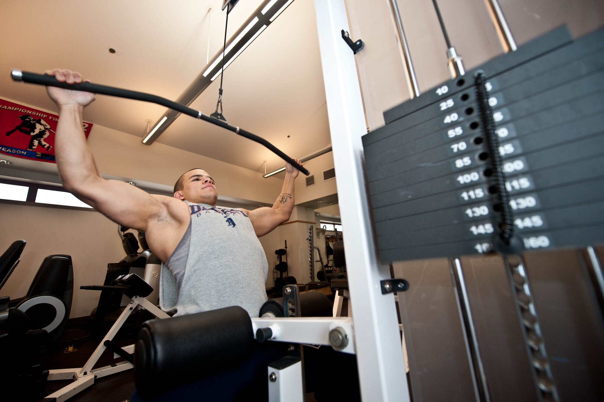 Senior Airman Brandon Stout, 28th Civil Engineer Squadron fire and emergency services driver operator, performs pull downs at the fire station on Ellsworth Air Force Base, S.D., Jan. 8, 2013. Stout recently won the 2012 Wyoming Powerlifting State Championship, 2012 Sioux Empire Bench Championship and the 2012 Ellsworth’s Strongest Championship.  He currently holds the state record for South Dakota and Wyoming in the squat, bench press, dead lift and total categories. (U.S. Air Force photo by Airman 1st Class Zachary Hada/Released)