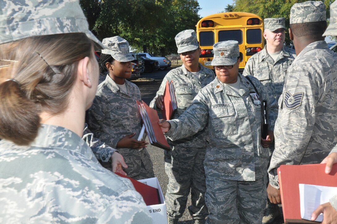 Major Yolanda Woodsmall, 908th ASTS, turns in her mobility folder during deployment outprocessing practice.