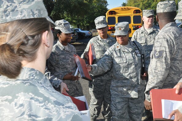 Major Yolanda Woodsmall, 908th ASTS, turns in her mobility folder during deployment outprocessing practice.
