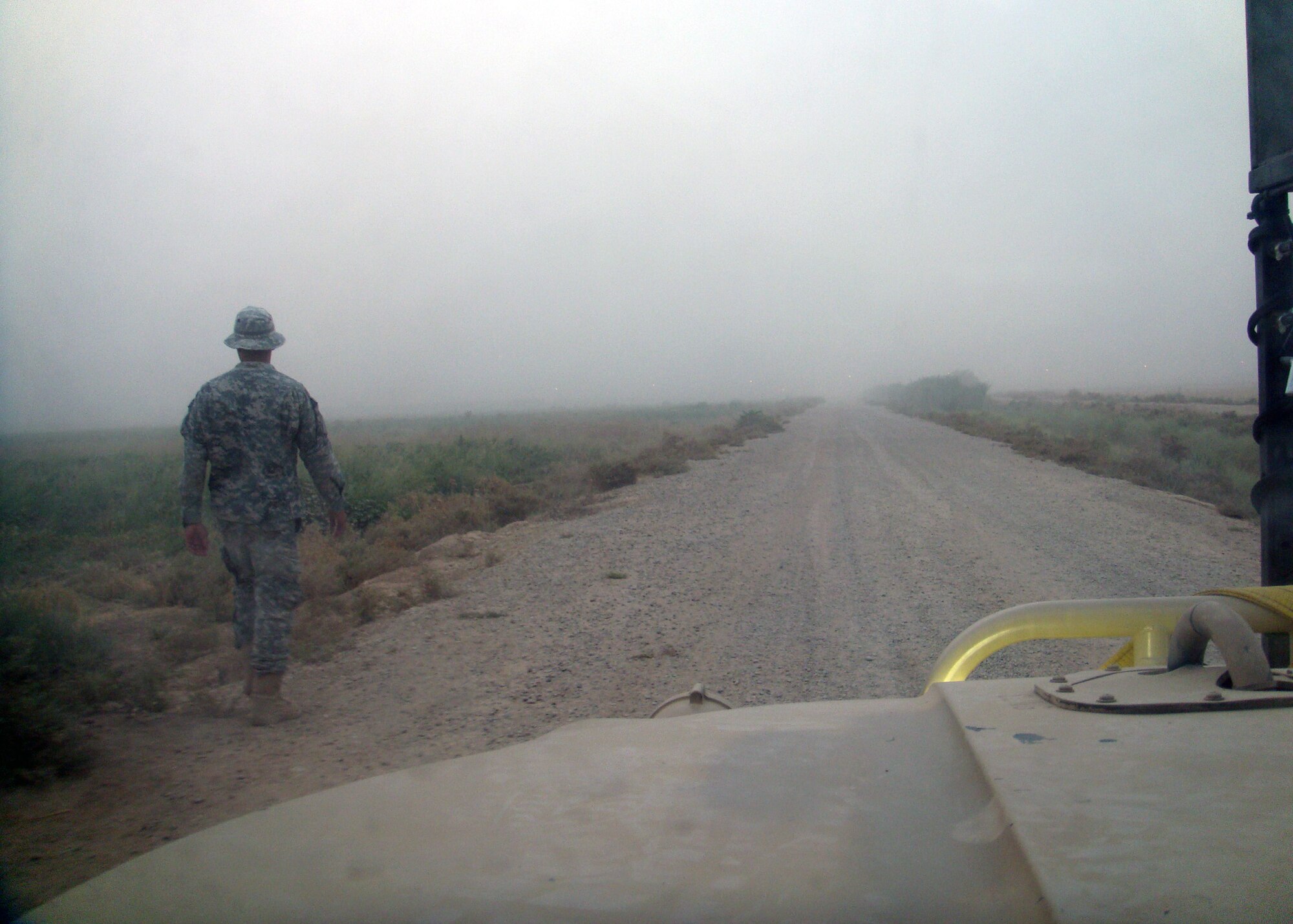 Staff Sgt. Daniel Ball, 366th Security Forces Squadron controller, walks in front of a convoy on an Iraqi roadway. Ball has worked with Army Special Forces and the 820th Battle Group from Moody Air Force Base, Ga. He’s done everything from combat operations to treating a female Iraqi teenager who was wounded when a stove allegedly blew up on her. (Courtesy photo)