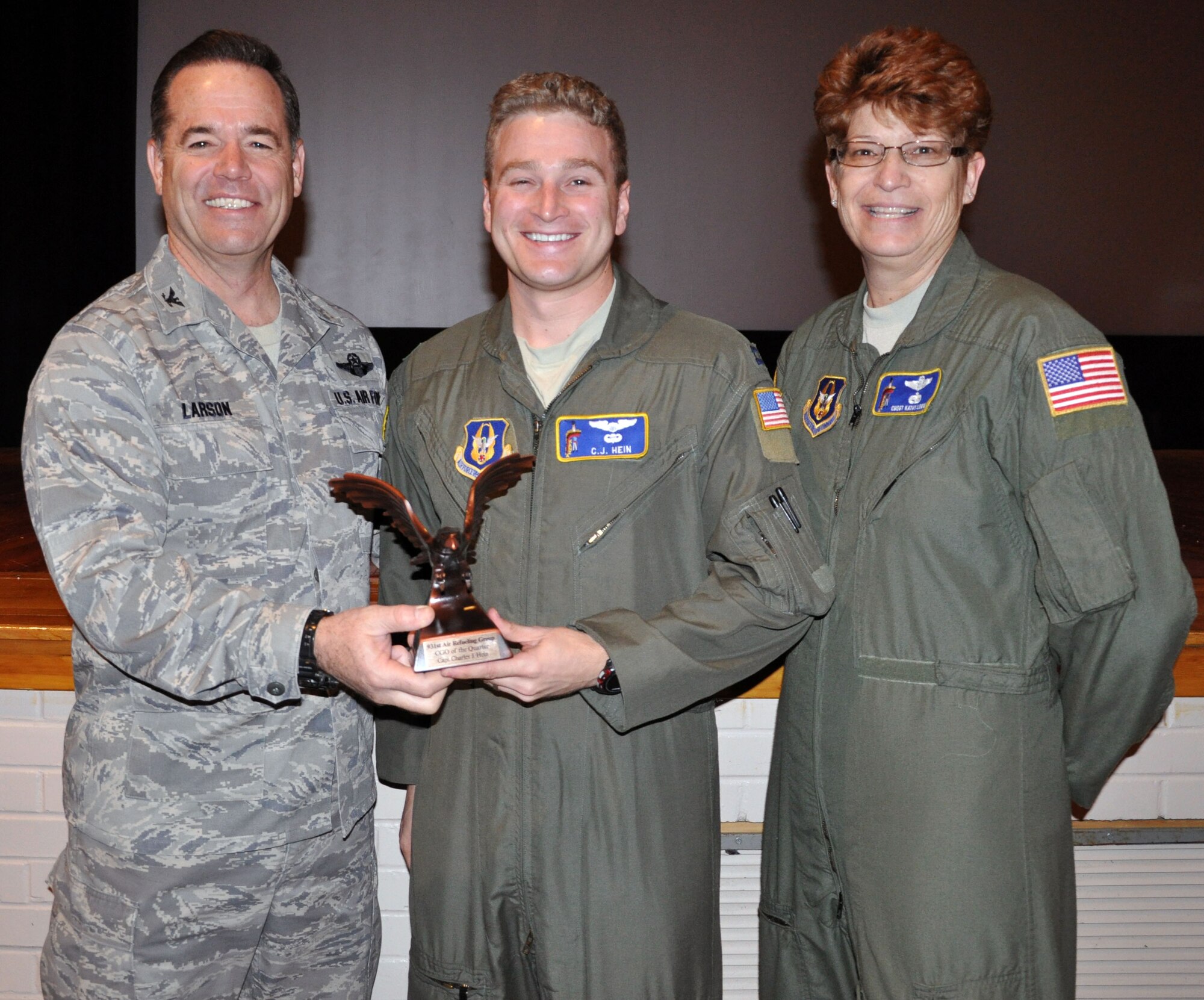 Col. Mark S. Larson, commander of the 931st Air Refueling Group, and Chief Master Sgt. Kathy Lowman, 931 ARG Superintendent, present the company grade officer of the quarter award to Capt. C.J. Hein at McConnell Air Force Base, Kan., Jan 14, 2013.  Hein was selected for the award while deployed and the award presentation was delayed until his return home. (U.S. Air Force photo by 1st Lt. Zach Anderson)