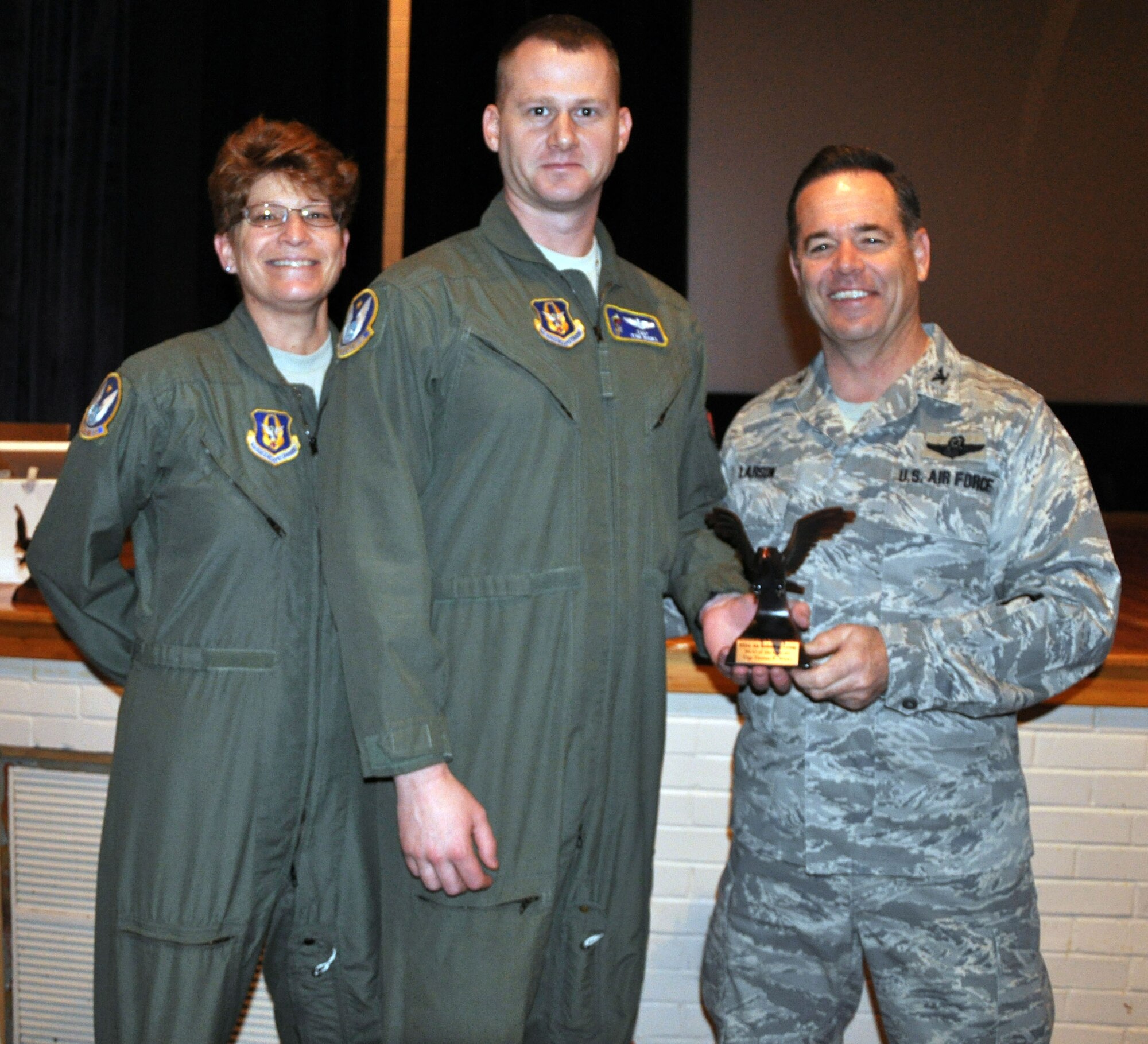 Col. Mark S. Larson, commander of the 931st Air Refueling Group, and Chief Master Sgt. Kathy Lowman, 931 ARG Superintendent, present the noncommissioned officer of the quarter award to Tech. Sgt. Tom Wicks at McConnell Air Force Base, Kan., Jan 14, 2013.  Wicks was selected for the award while deployed and the award presentation was delayed until his return home. (U.S. Air Force photo by 1st Lt. Zach Anderson)