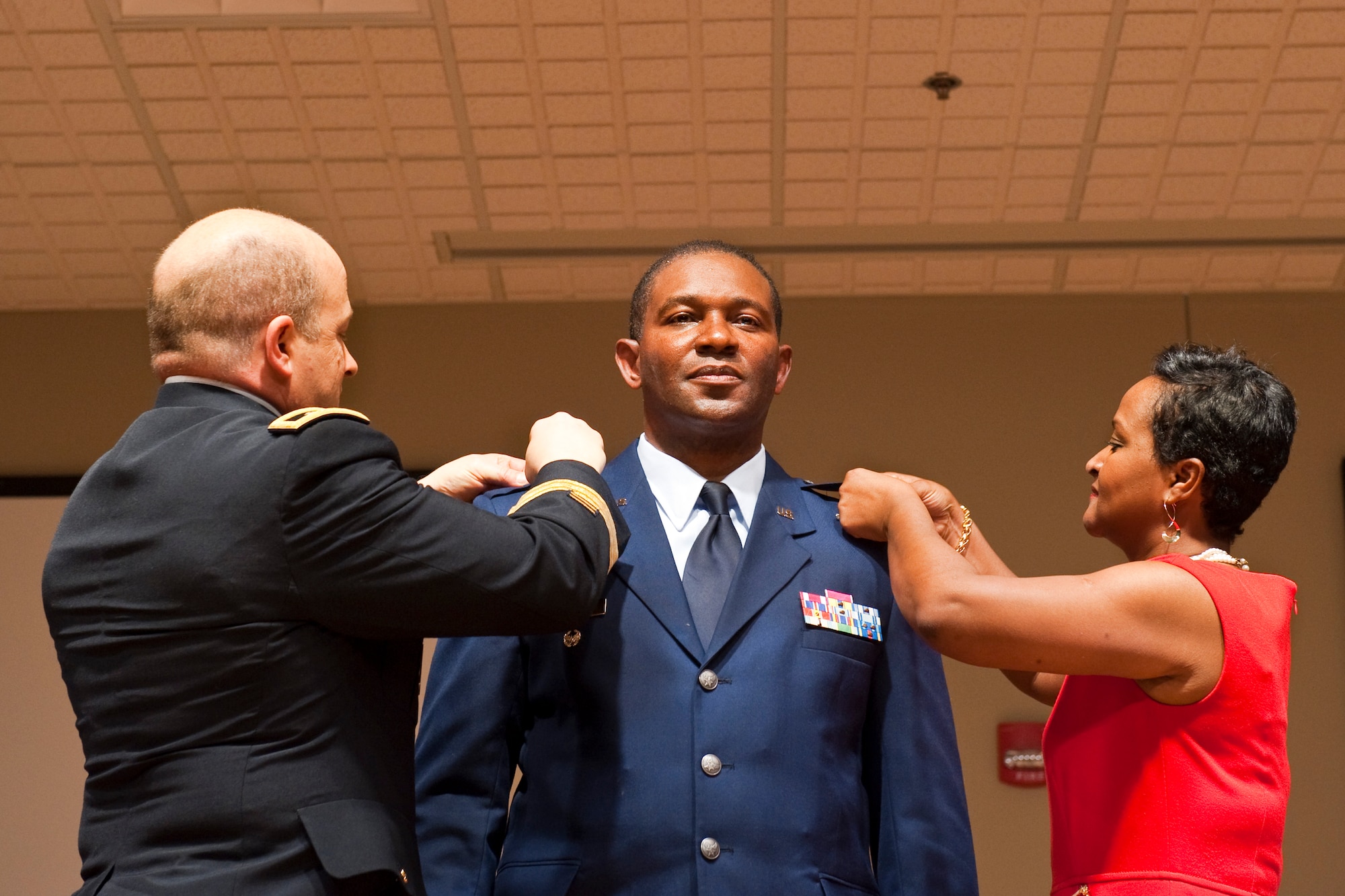 South Carolina Adjutant General, Maj. Gen. Robert E. Livingston, Jr. and Mrs. Mary Elam, pin newly promoted Brig. Gen. Calvin H. Elam, at a ceremony at McEntire Joint National Guard Base on January 13, 2013. Elam becomes the South Carolina Air National Guard's first black general officer. Elam has served as the Assistant Adjutant General for Air for the South Carolina National Guard since January 2012. As a civilian, he is Chief Executive Officer for Elam Financial Group. (National Guard photo by Staff Sgt. Jorge Intriago/Released)