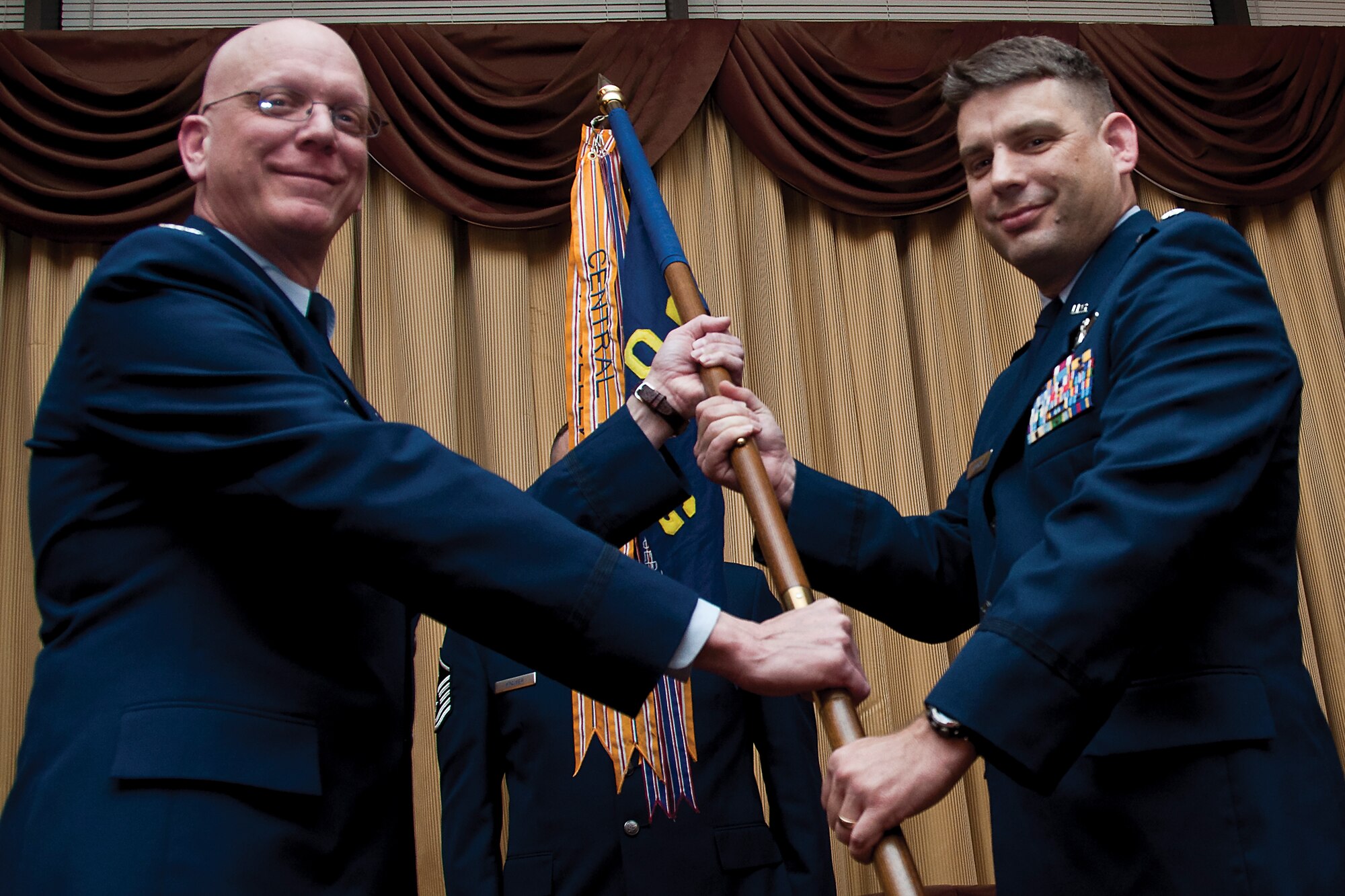 Lt. Col. Ken Ostrat takes the guidon for the 514th Operations Group from Col. Michael Underkofler, 514th Air Mobility Wing commander, at an assumption-of-command ceremony at the community center here Jan. 12. Ostrat assumed command of the operations group. He recently served as the 908th Operations Group director of operations at Maxwell Air Force Base, Ala. (U.S. Air Force photo by Shawn J. Jones)